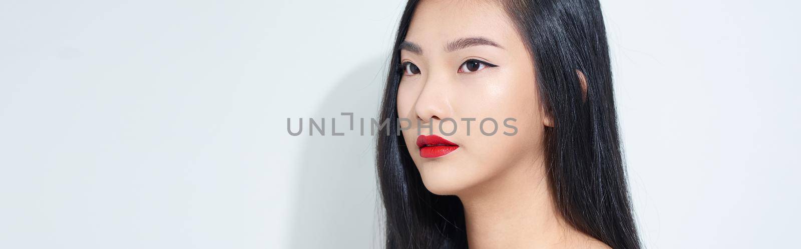 Beautiful young Asian woman on white background by makidotvn