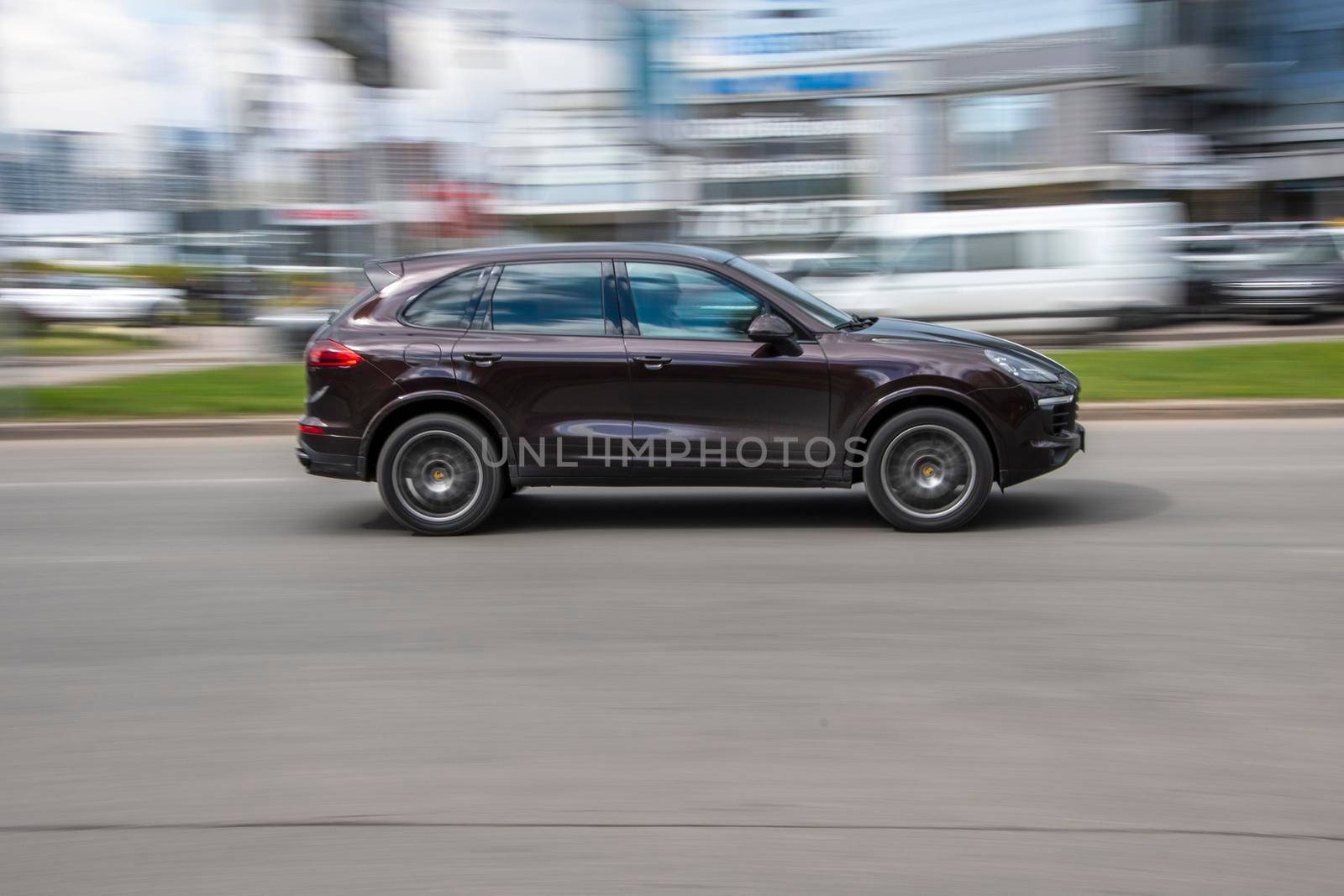 Ukraine, Kyiv - 26 April 2021: Brown Porsche Cayenne car moving on the street. Editorial