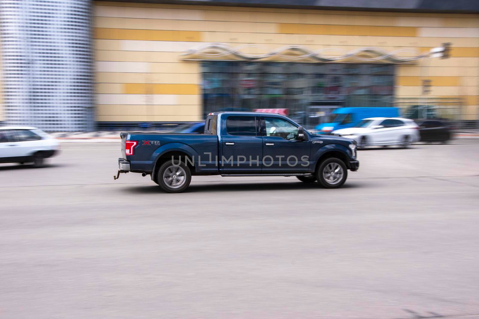 Ukraine, Kyiv - 26 April 2021: Black Ford F-150 car moving on the street. Editorial