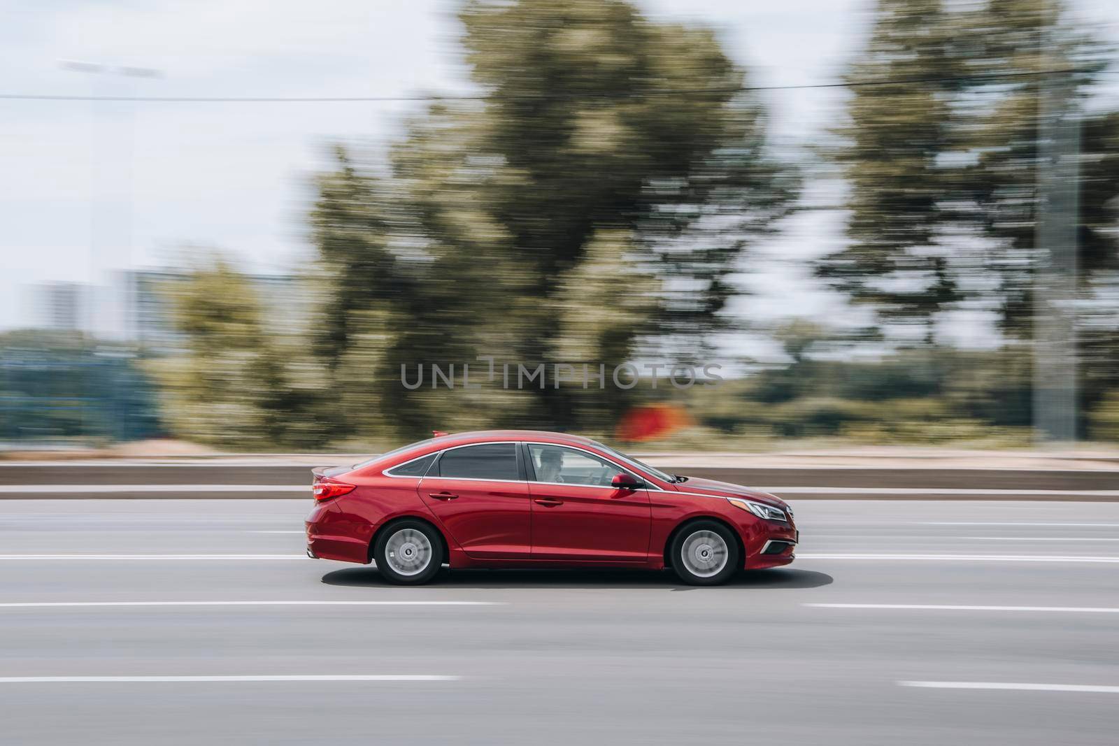 Ukraine, Kyiv - 27 June 2021: Red Hyundai Sonata car moving on the street. Editorial
