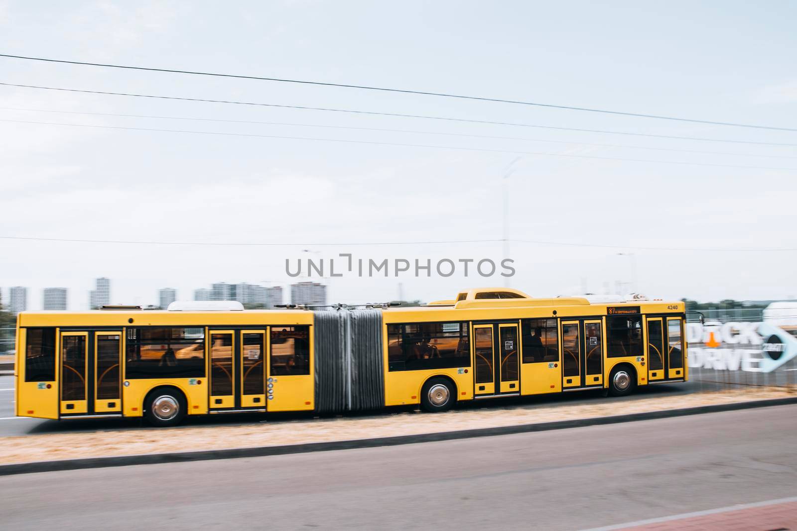 Ukraine, Kyiv - 27 June 2021: Yelow Municipal Bus moving on the street. Editorial by Yuriy_Vlasenko