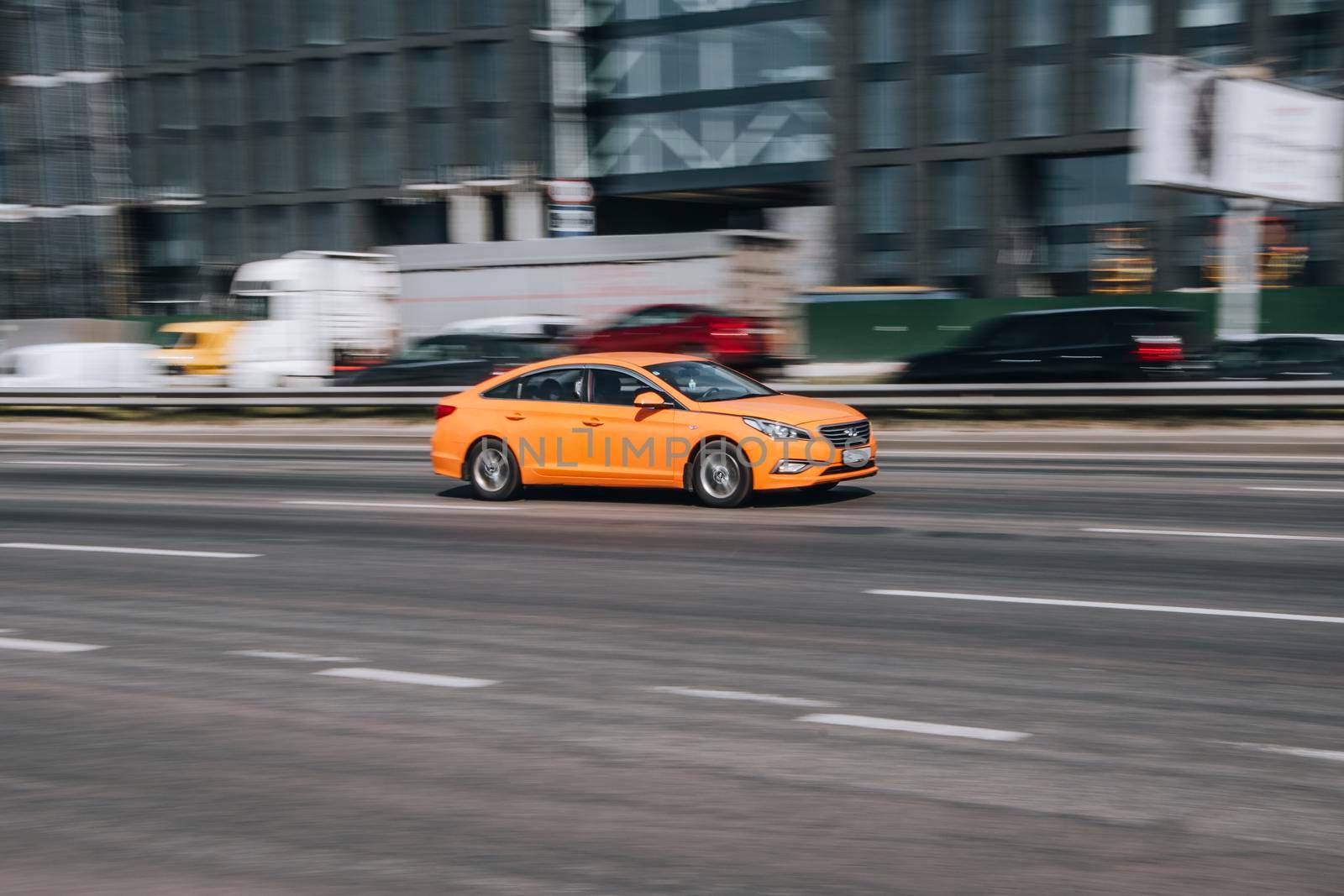 Ukraine, Kyiv - 29 April 2021: Orange Hyundai Sonata car moving on the street. Editorial