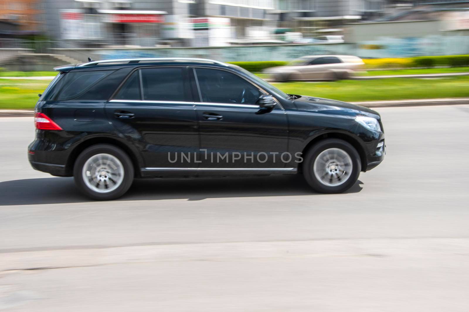 Ukraine, Kyiv - 26 April 2021: Black Mercedes-Benz M-klasse car moving on the street. Editorial