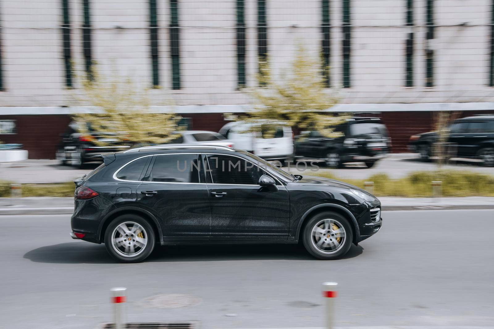 Ukraine, Kyiv - 13 May 2021: Black Porsche Cayenne car moving on the street. Editorial