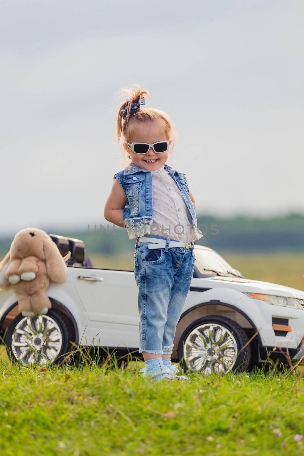 girl in sunglasses stands in front of a car by zokov