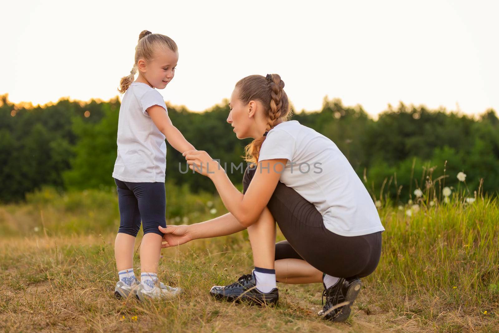 mother and daughter exercising outdoors