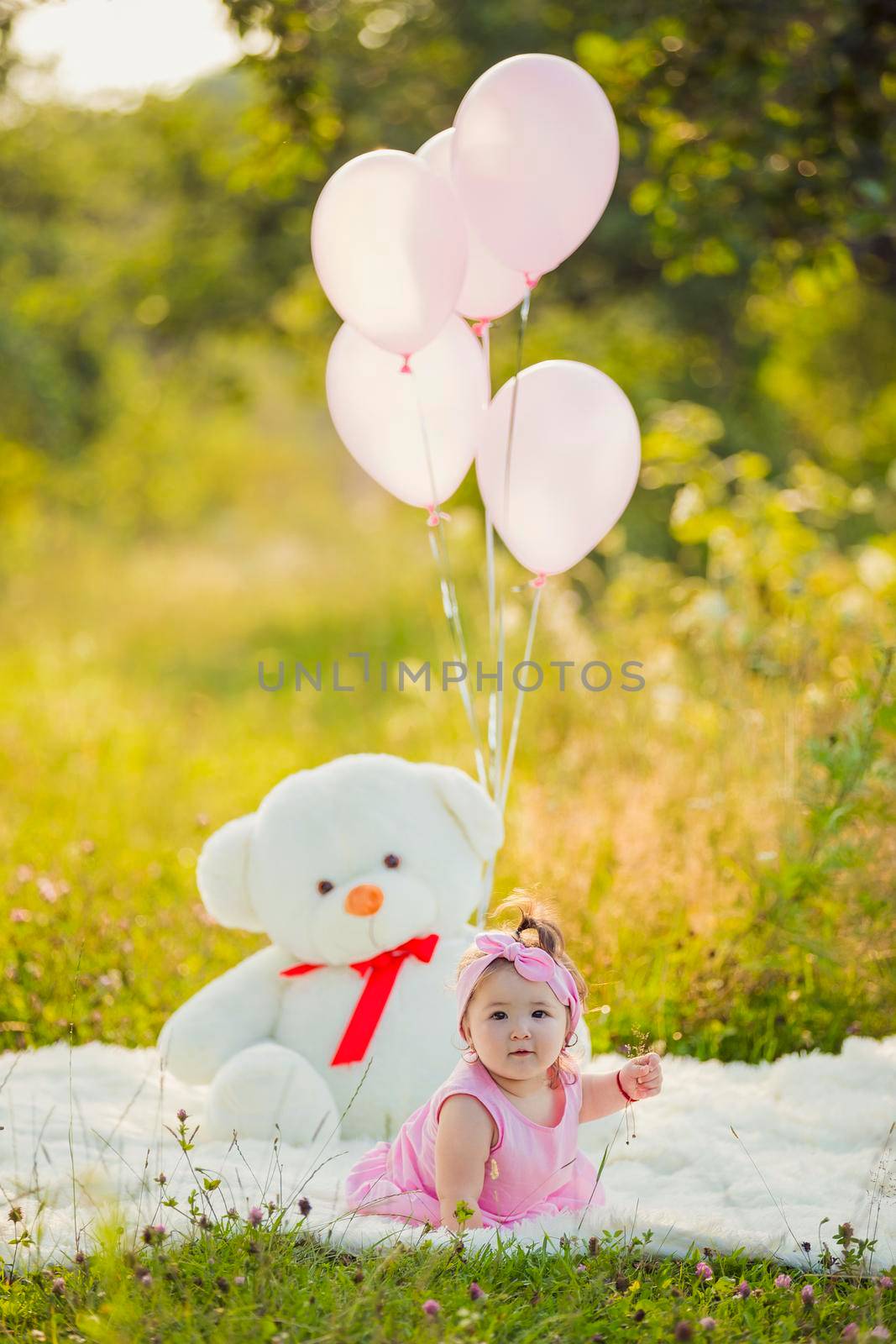 child with balloons in nature