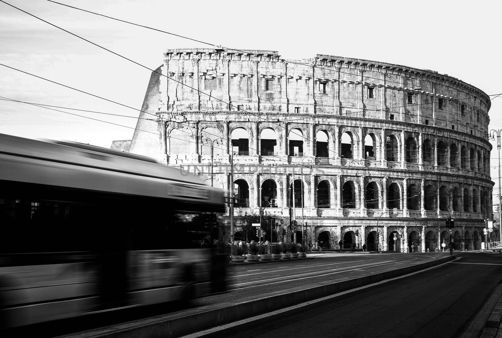 Roma, Italy, 27/11/2019: Rome Colosseum with buses moving in city traffic, travel reportage