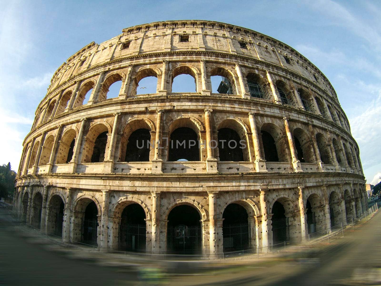 Roma, Italy, 01/19/2015: the ancient colosseum of Rome during a sunny day and photographed with a fisheye lens, travel reportage