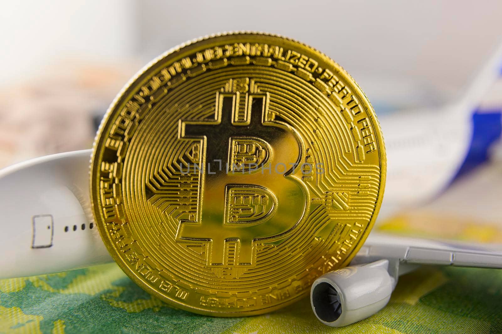 Bitcoin, euro and airplane close up