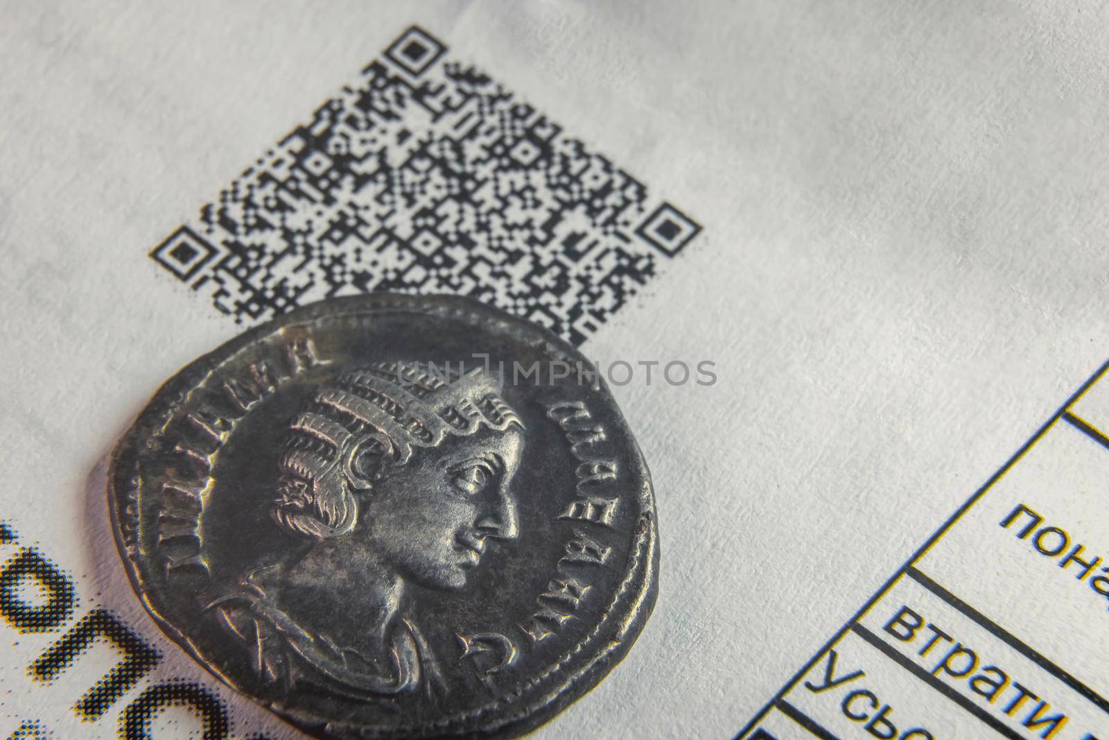 an old coin on a sheet of paper with a cuar code by zokov