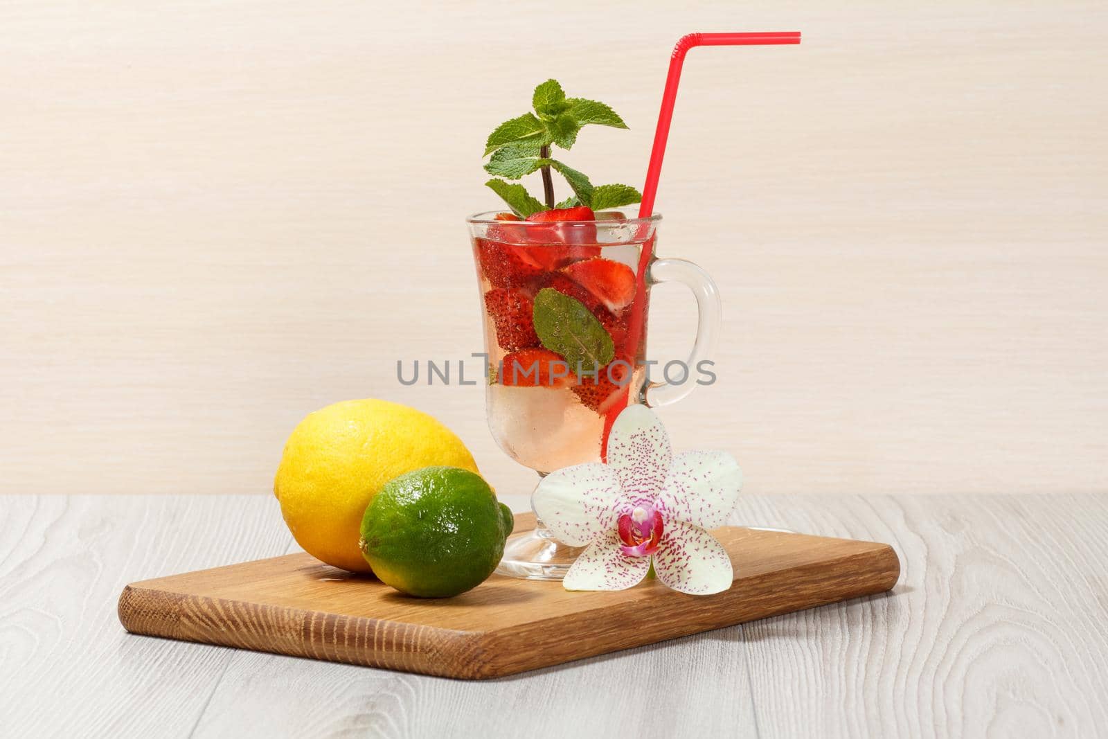 Carbonated lemonade with strawberry slices and mint on an wooden cutting board, Cold beverage for hot summer day