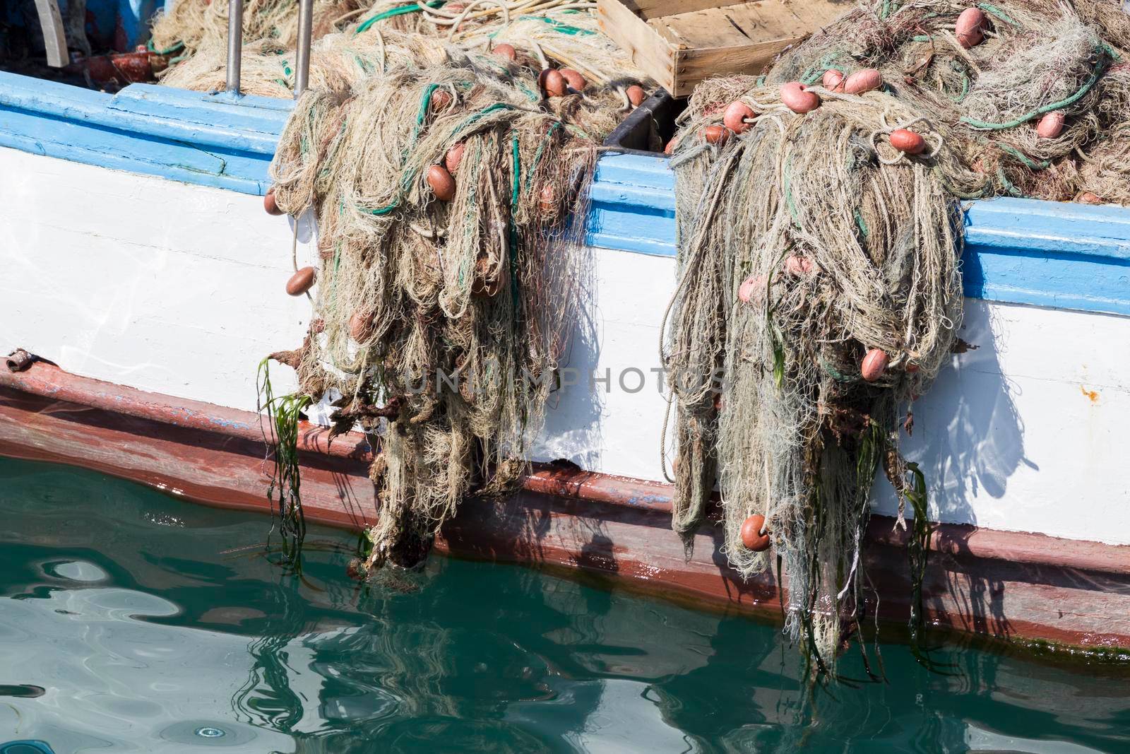 A fishing vessel with nets ready to fish.