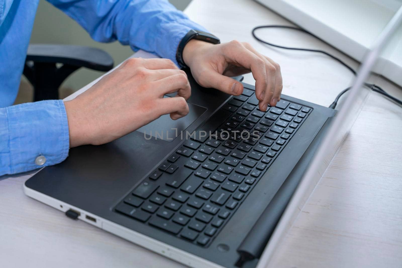 Close up of mans hand typing on laptop keyboard, businessman programmer working concept