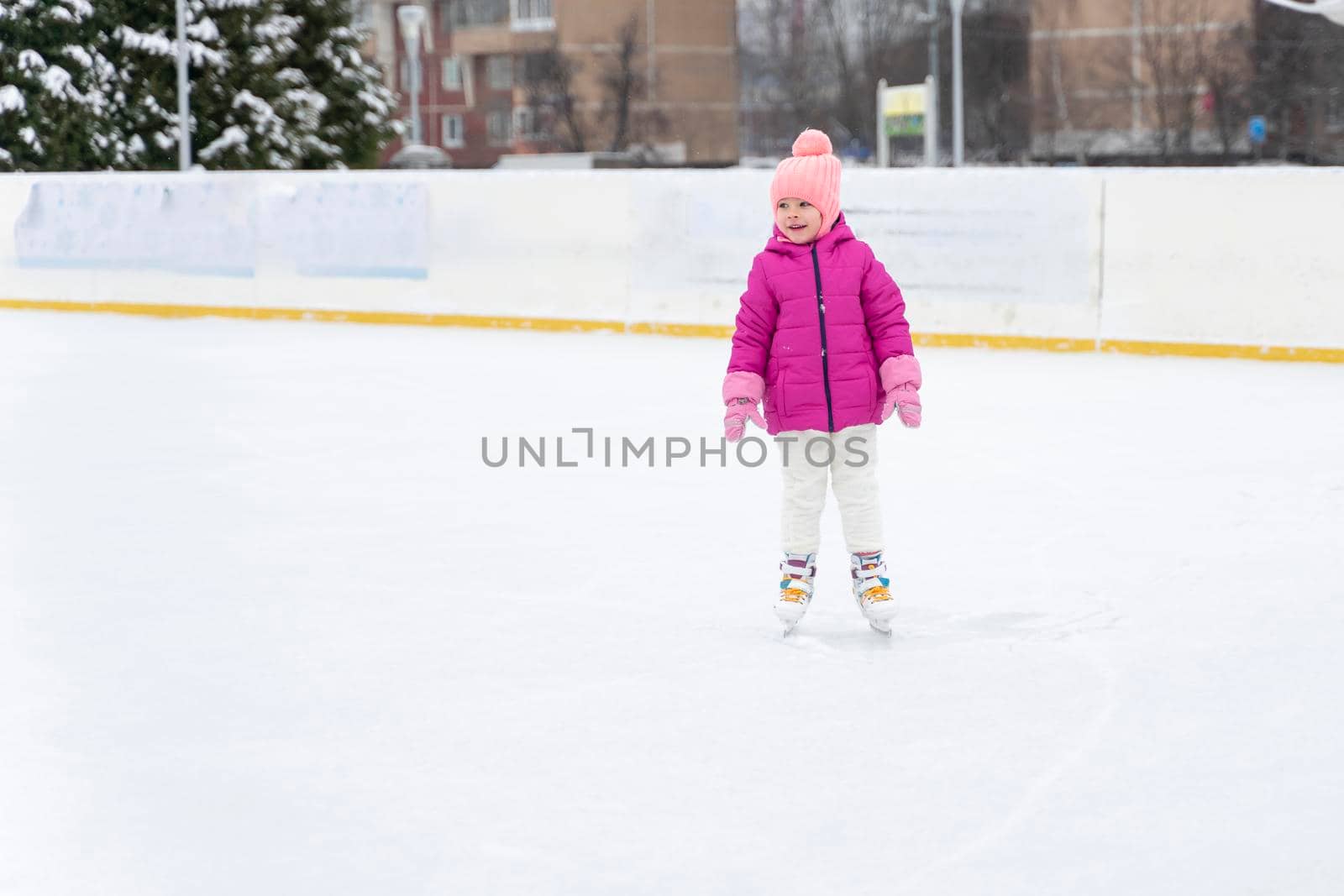 little girl ice skating on the ice rink by Lena_Ogurtsova