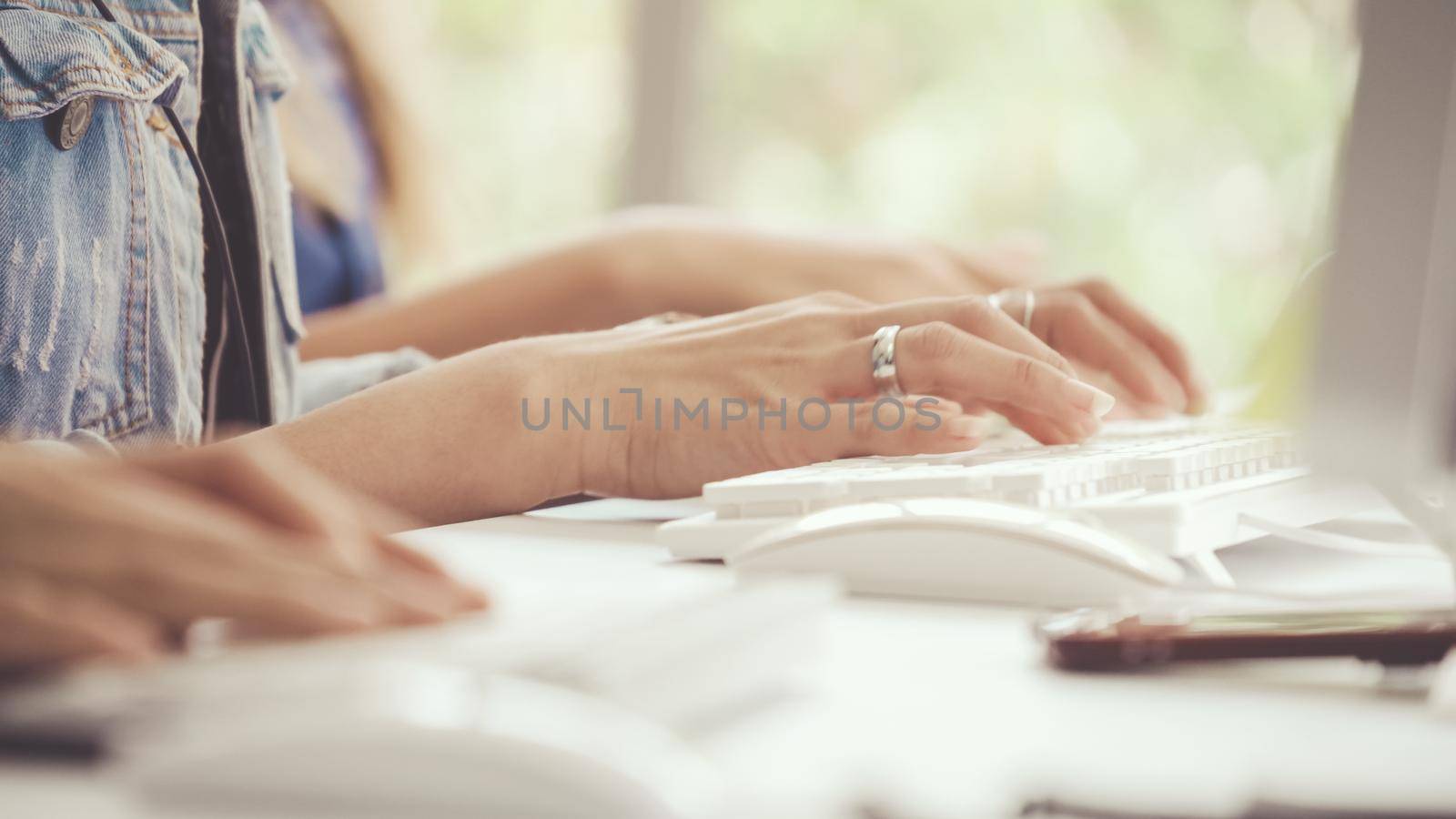 Close up shot of businesswoman hand typing and working on desktop computer on the office desk. Business communication and workplace concept.