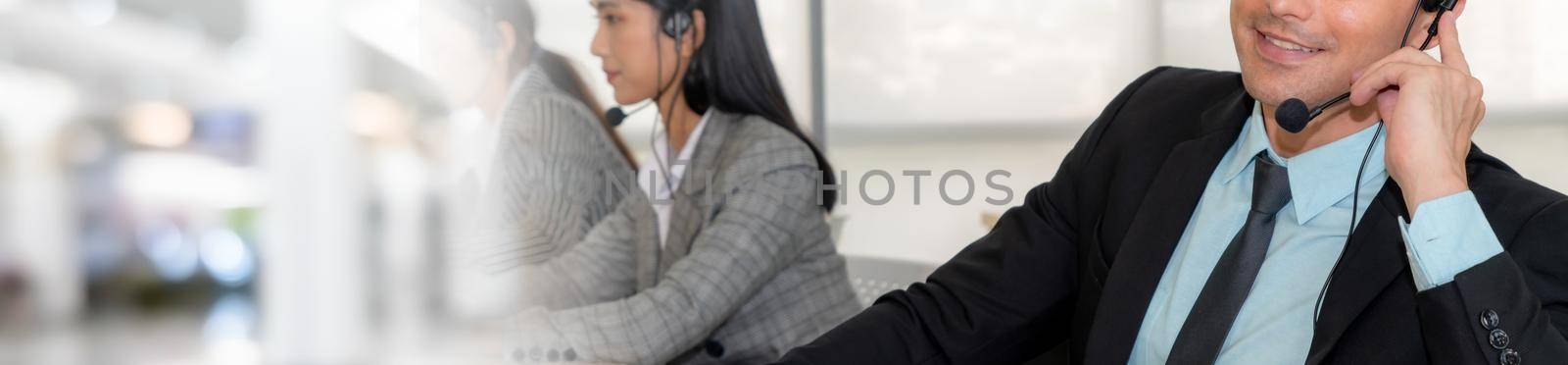 Call center or customer support agent in broaden view panoramic banner wearing headset while working at office to support remote customer or colleague on telephone video conference call