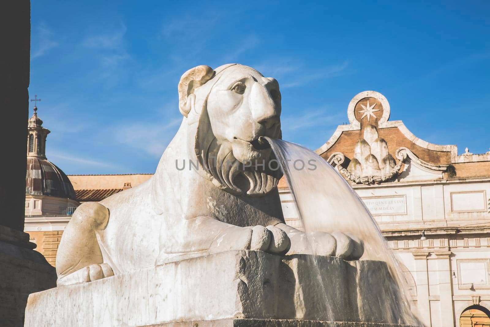 Roma, Italy, 26/11/2019: Piazza del Popolo in Rome, sculpture of the lion fountain with flowing water, travel reportage