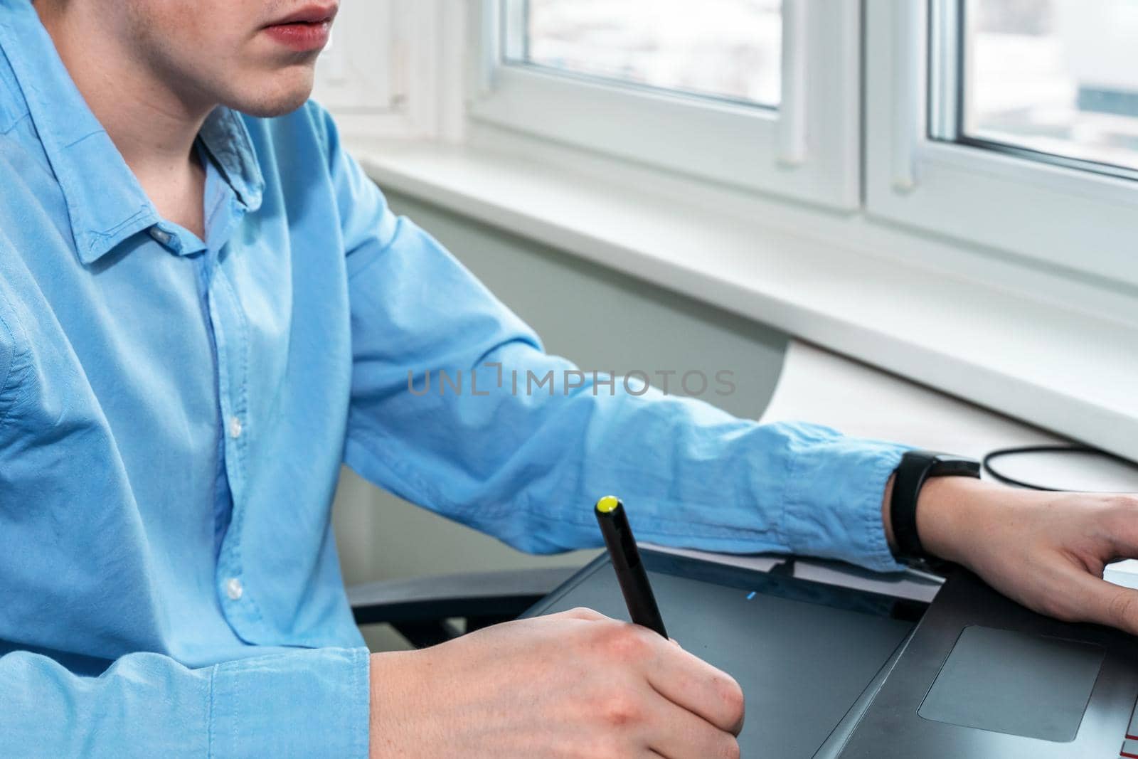 designer working on a professional tablet with a pen by Lena_Ogurtsova