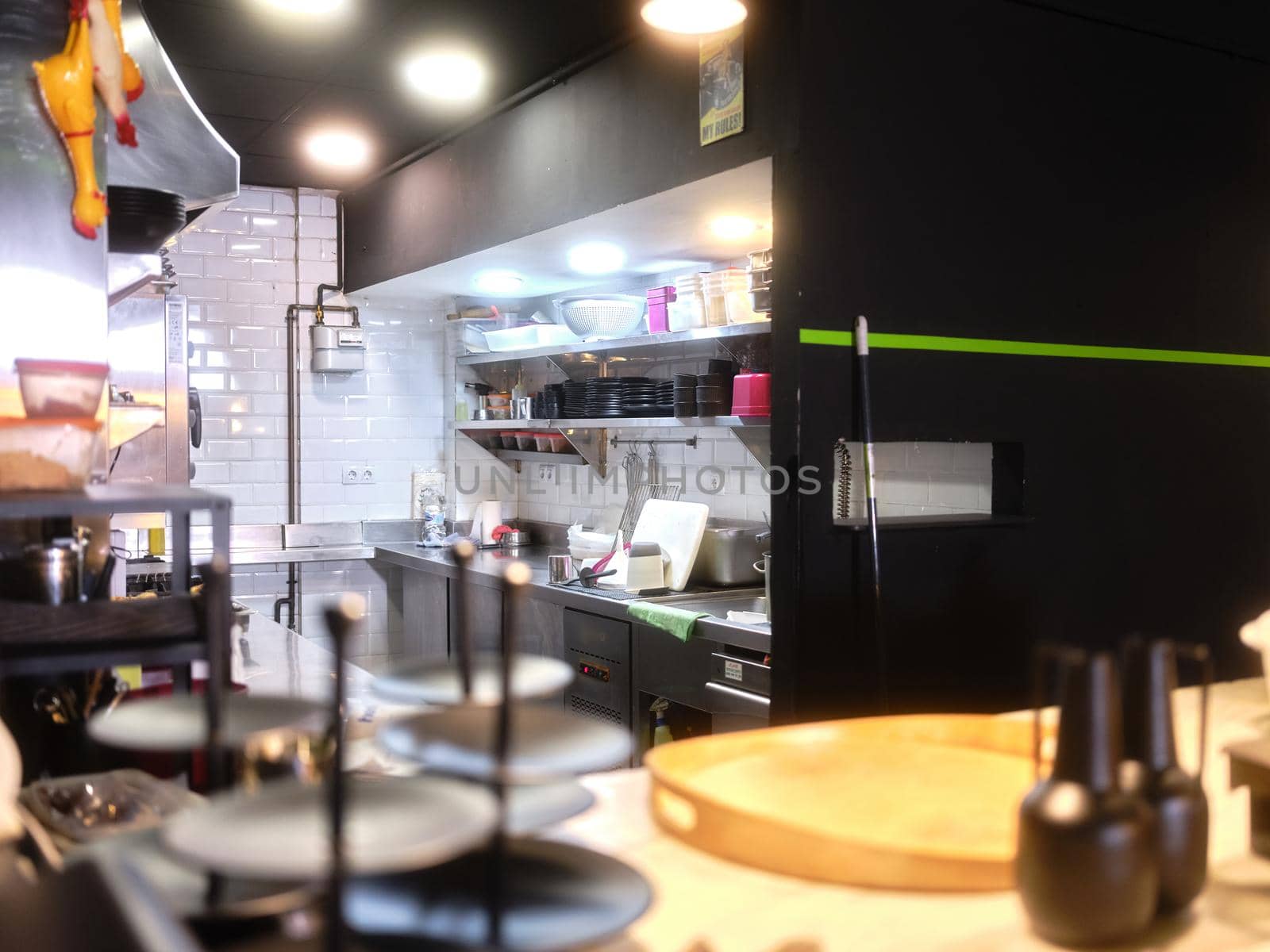 selective focus on a restaurant kitchen with plates stacked ready for service from the counter