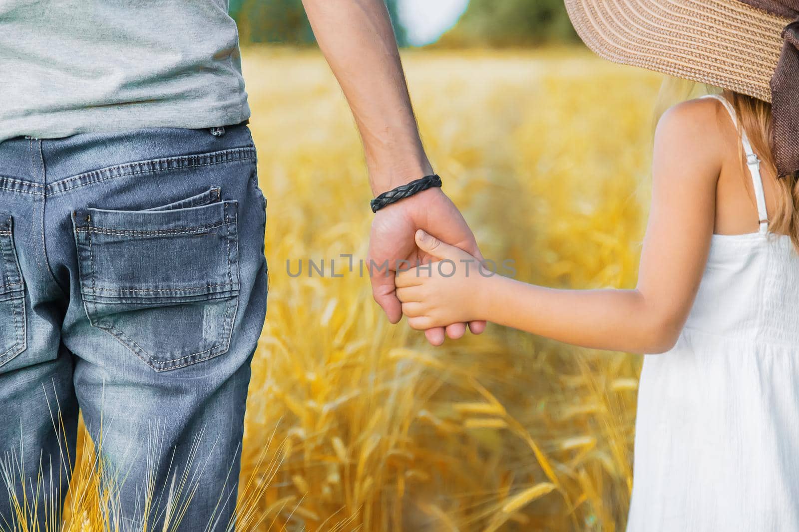 Child and father in a wheat field. Selective focus. nature.