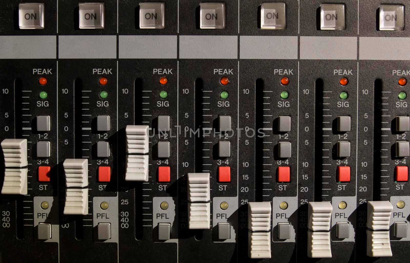 Front view of electronic mixer used to create music from a dj