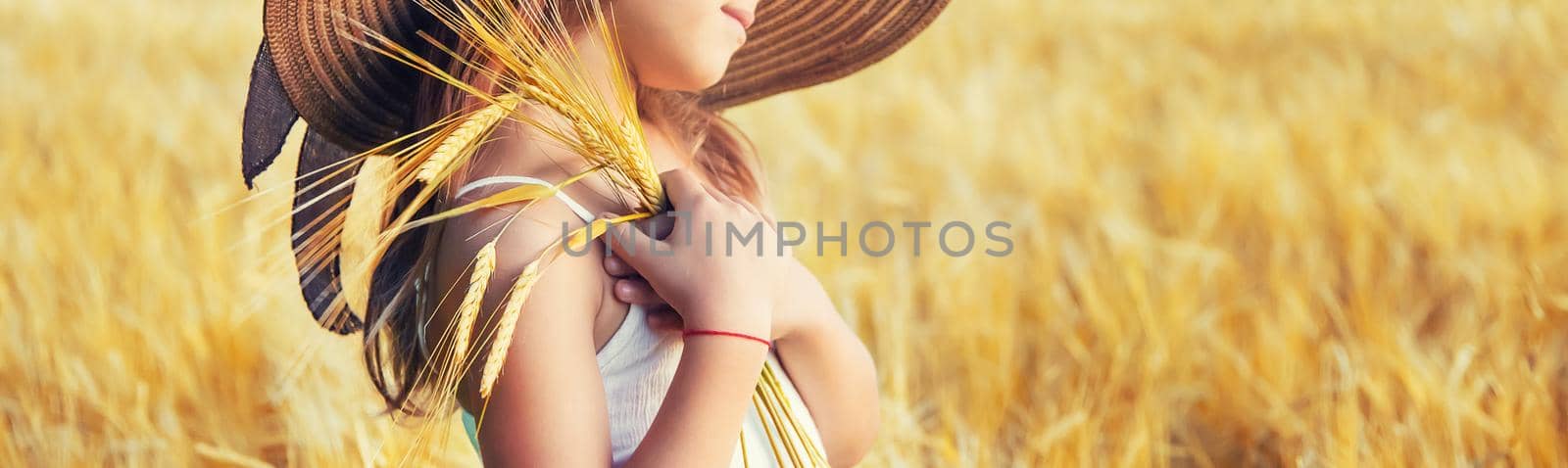 A child in a wheat field. Selective focus.