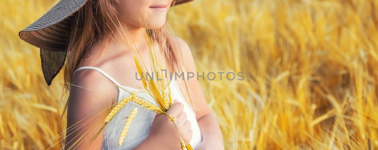 A child in a wheat field. Selective focus. by yanadjana