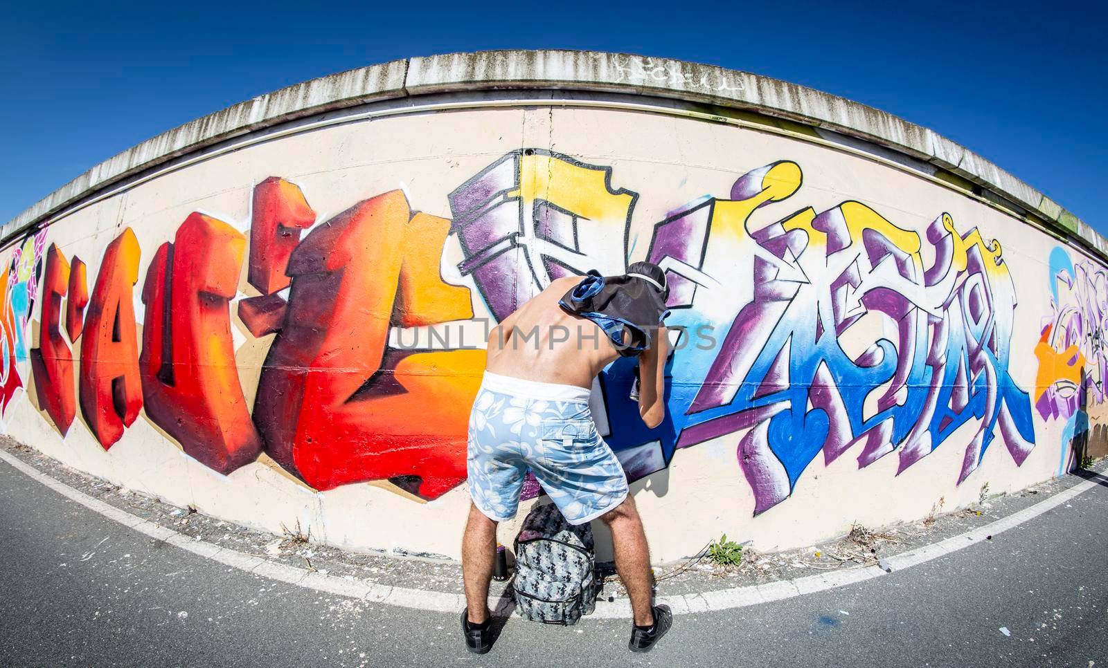 Imperia, Italy - 08/09/2018: Wall of Imperia city centre, Graffiti Artist Spray Painting Wall Art.