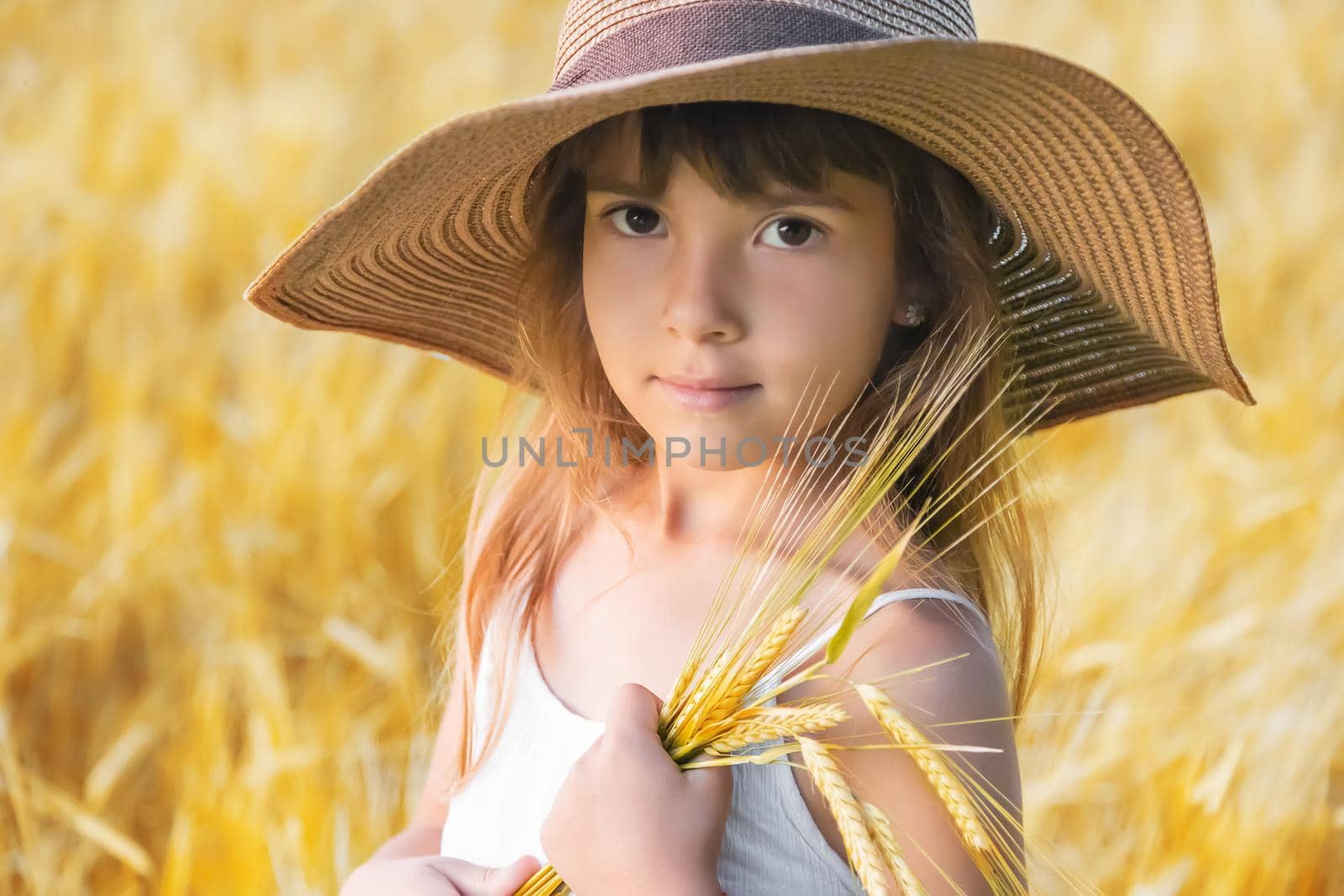 A child in a wheat field. Selective focus. by yanadjana