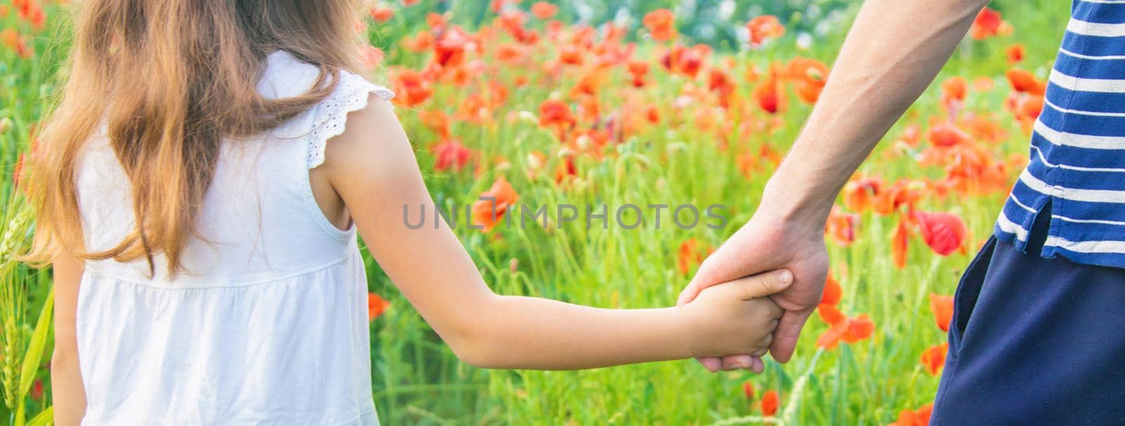 children girl in a field with poppies. selective focus. nature.