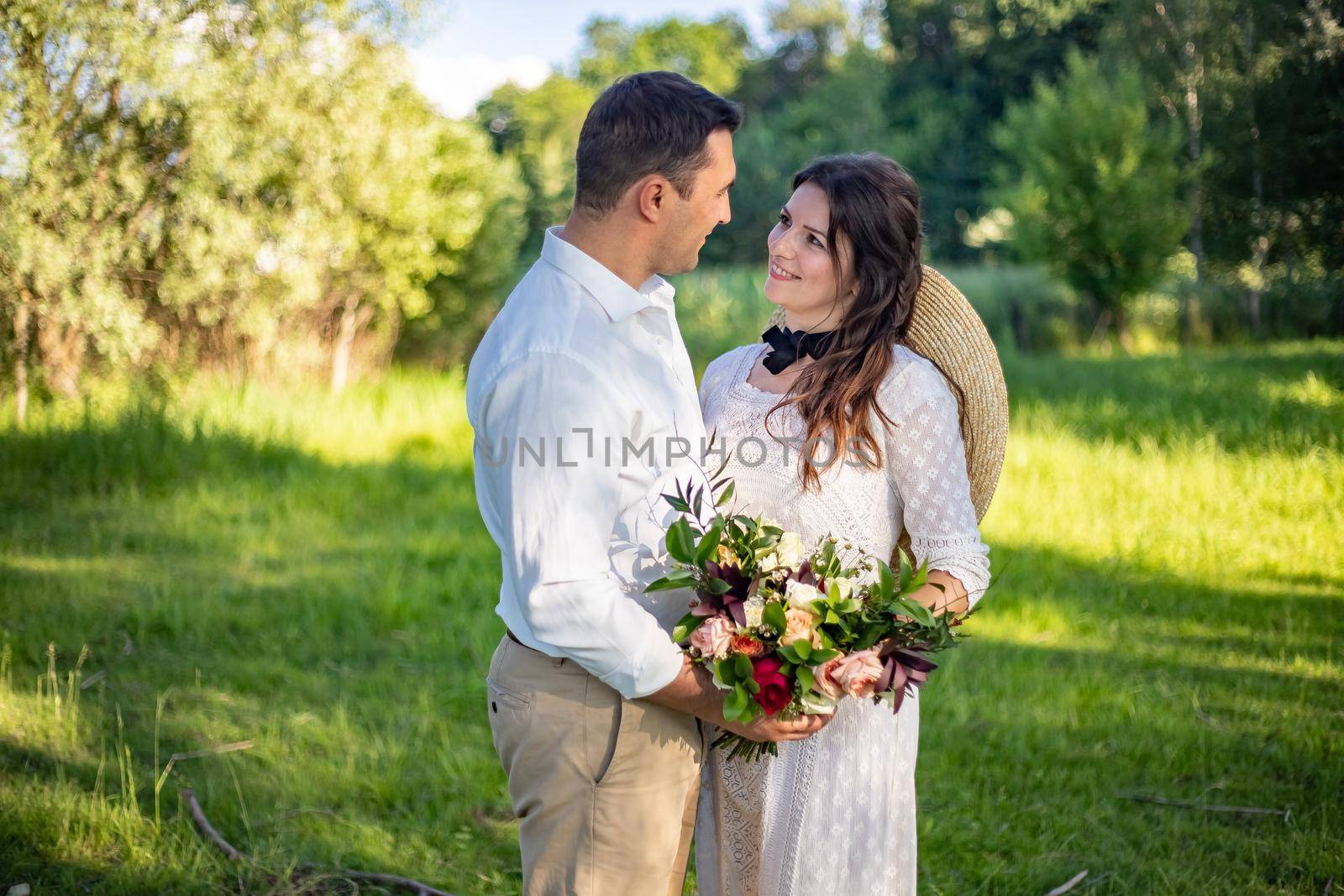 nice portrait of beautiful and young groom and bride outdoors