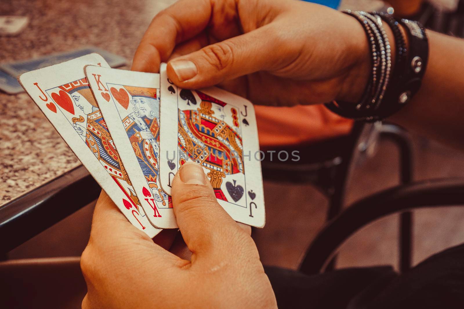 Hands using play cards