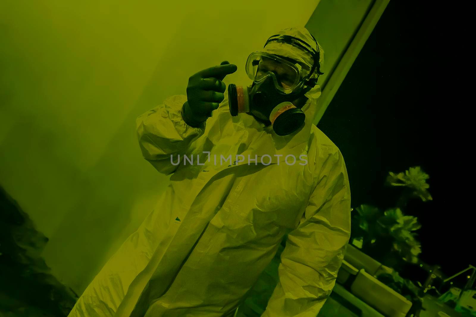 Health worker with antiviral suit and gas mask