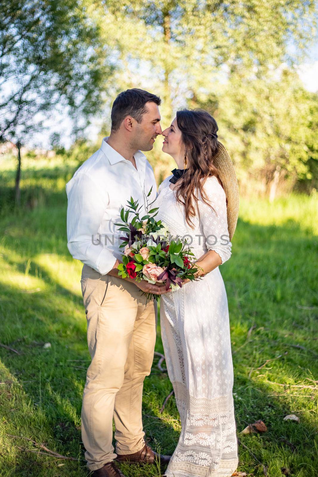 nice portrait of beautiful and young groom and bride outdoors