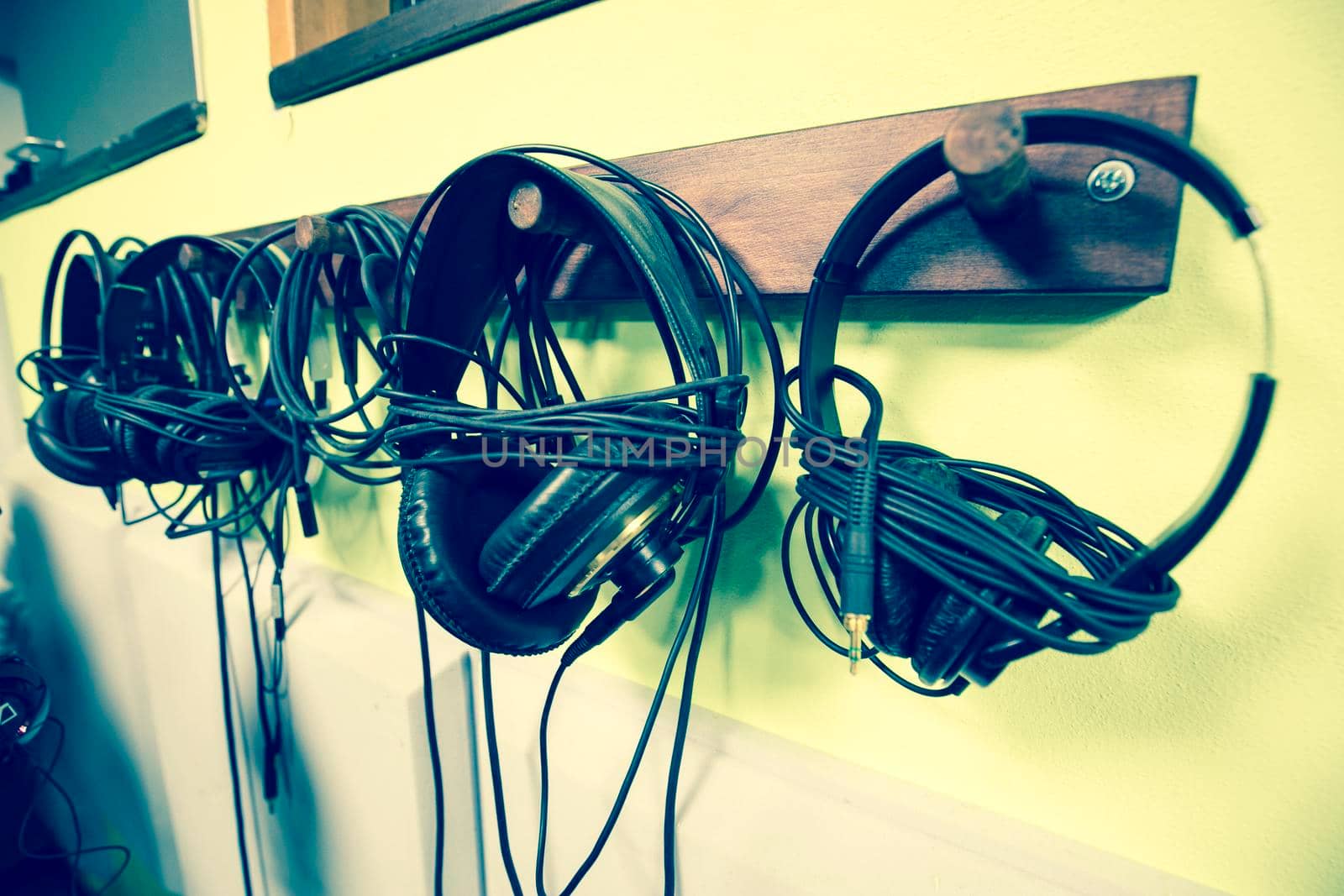 Set of headphones hung in a private studio recording