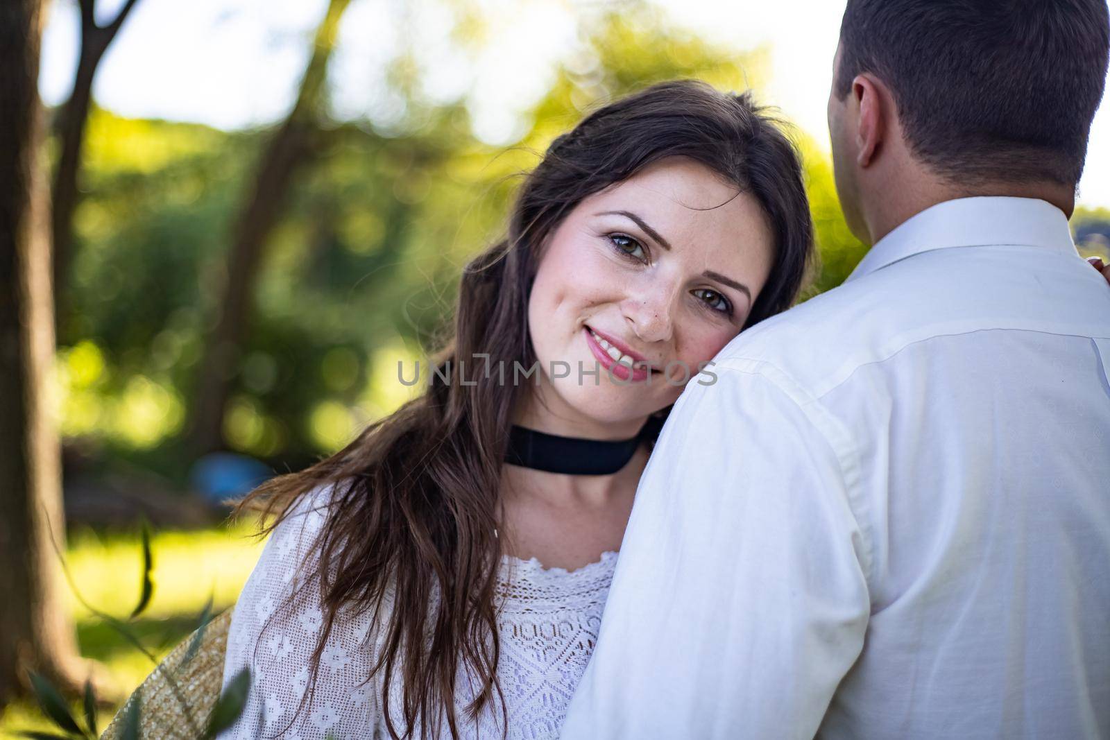 Portrait of a happy bride and groom, in boho style wedding dresses, against the backdrop of beautiful nature by Anyatachka