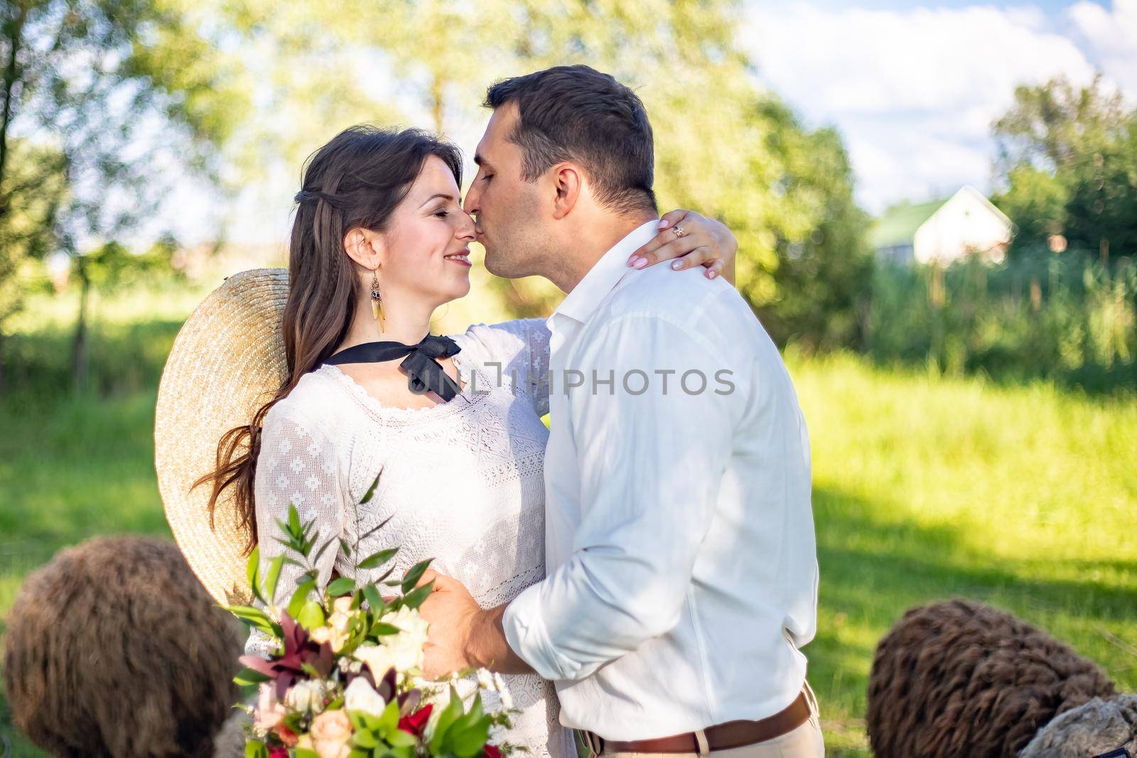 Wedding in the mountains. Beautiful couple of brides kissing standing on a mountain on a background of sunset in the mountains
