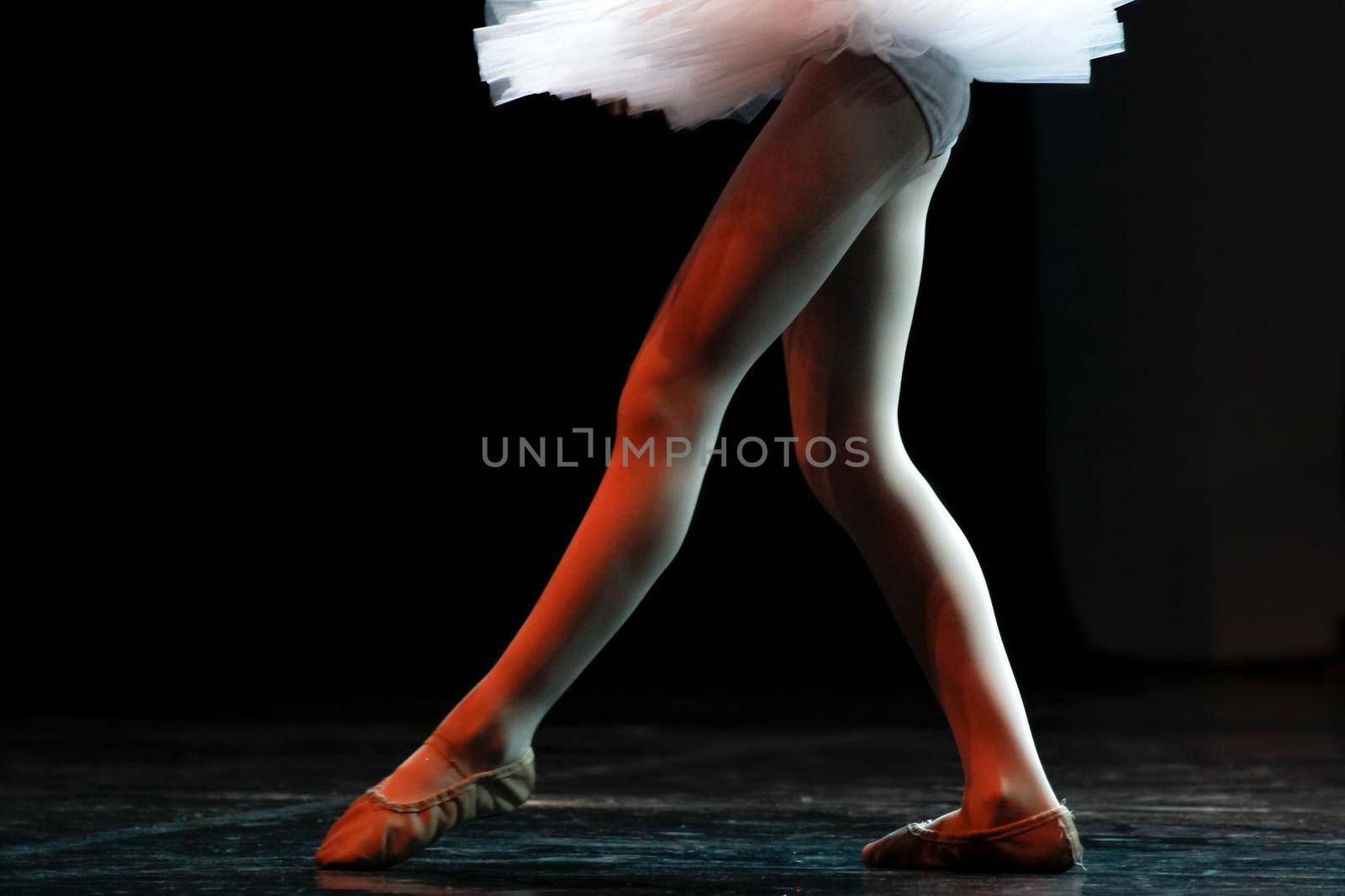 Legs of a young girl who practice classic Ballet.