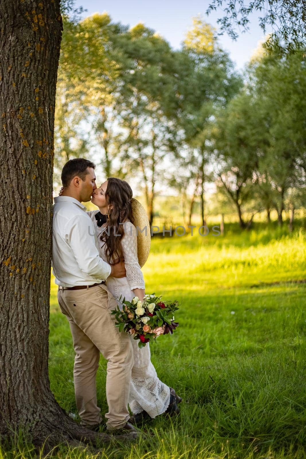 nice portrait of beautiful and young groom and bride outdoors