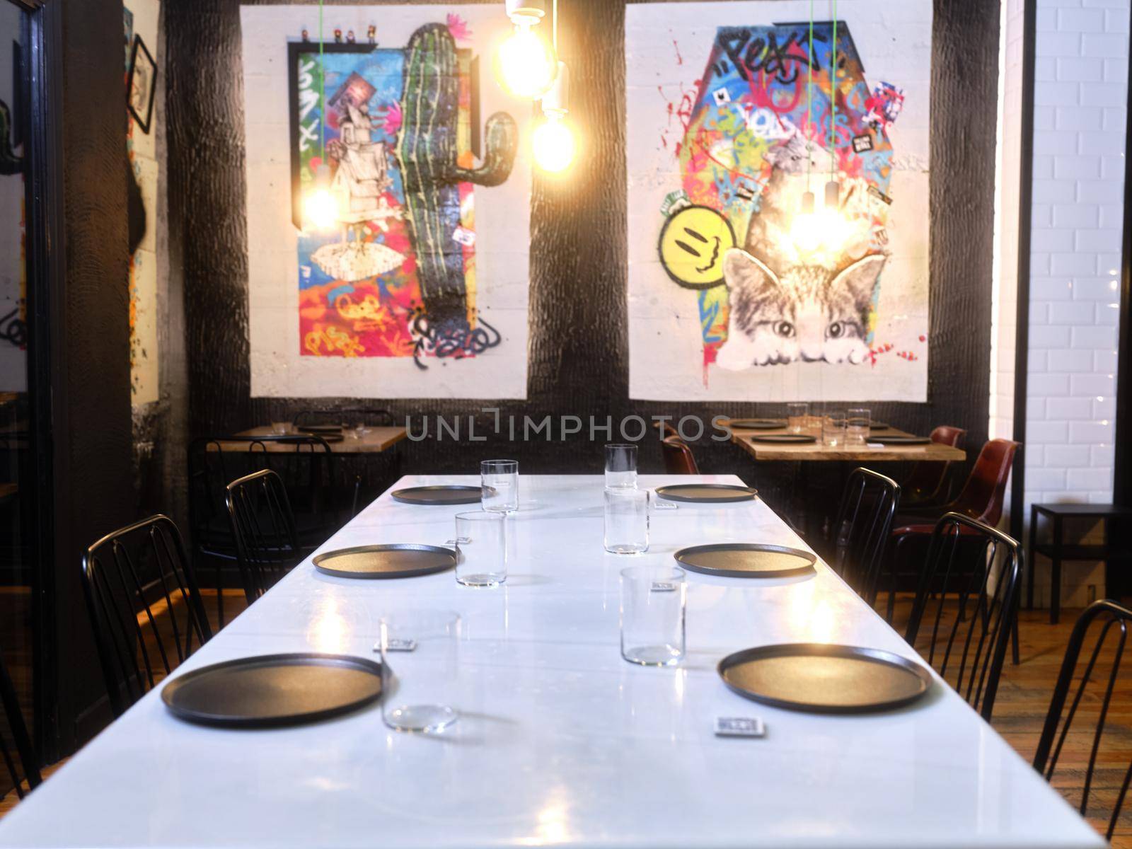 Restaurant table with contemporary paintings in the background by WesternExoticStockers