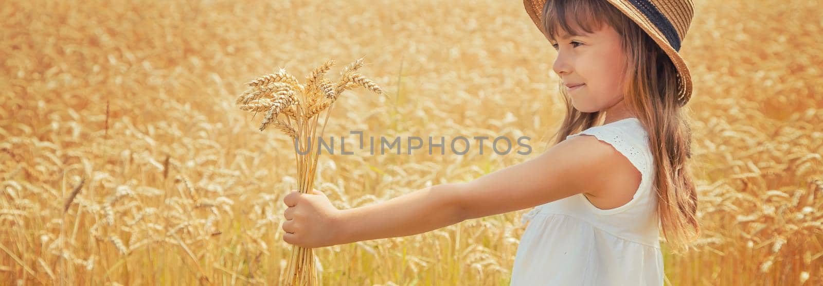 A child in a wheat field. Selective focus. by yanadjana