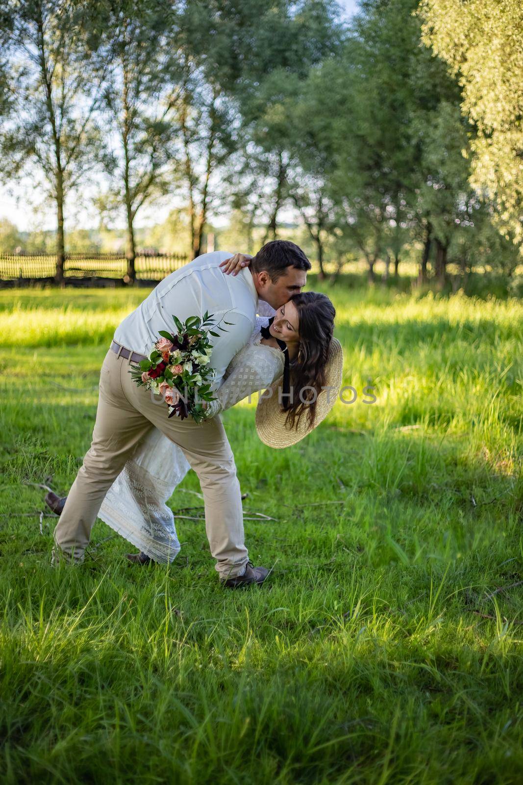 Romantic, young and happy caucasian couple in stylish clothes traveling together in the beautiful countryside nature. Love, relationships, romance, animal care, happiness concept.