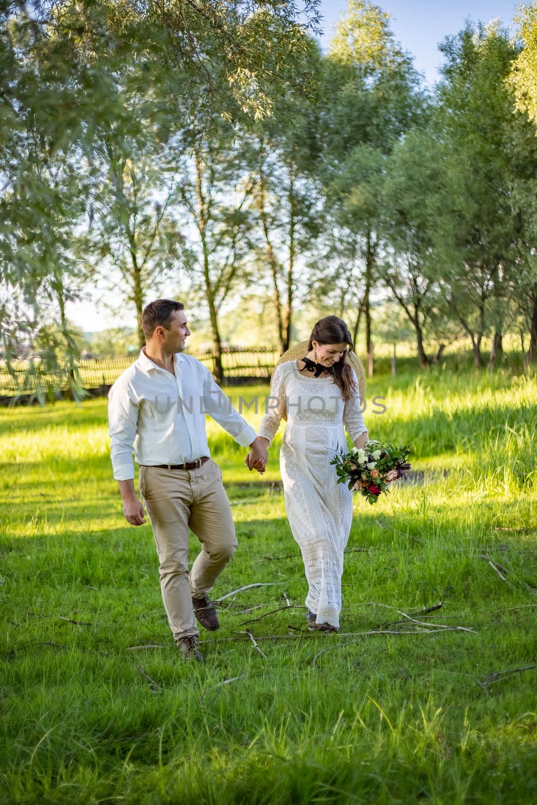 nice portrait of beautiful and young groom and bride outdoors