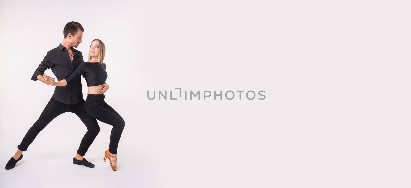 Bachata or salsa kizomba dancers on white background with copy space and place for text - Social dance and couple dancers concept