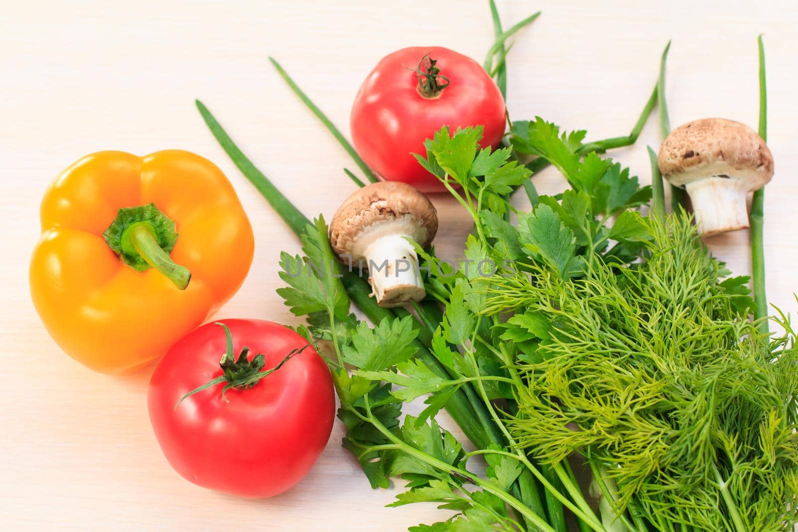 Set of good natural products with fresh pepper, tomato, mushrooms, onion, dill and parsley on the table