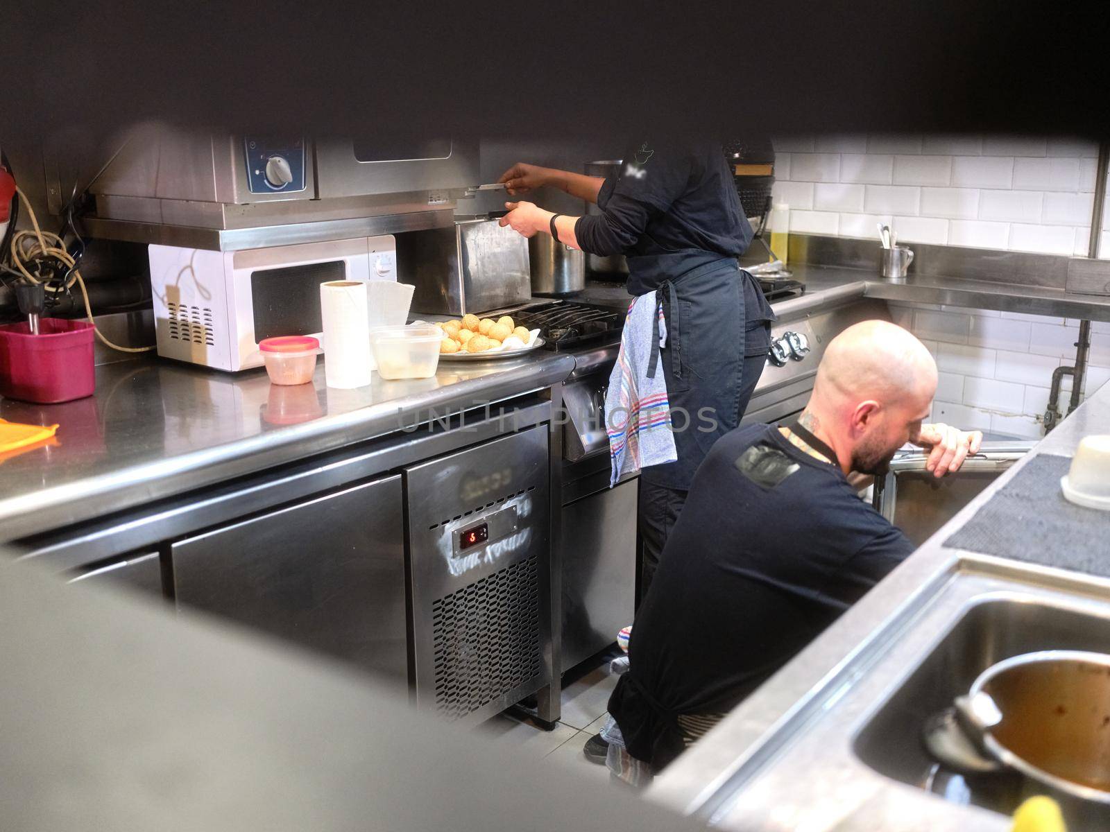 Work team in unifrom working on the kitchen of a restaurant