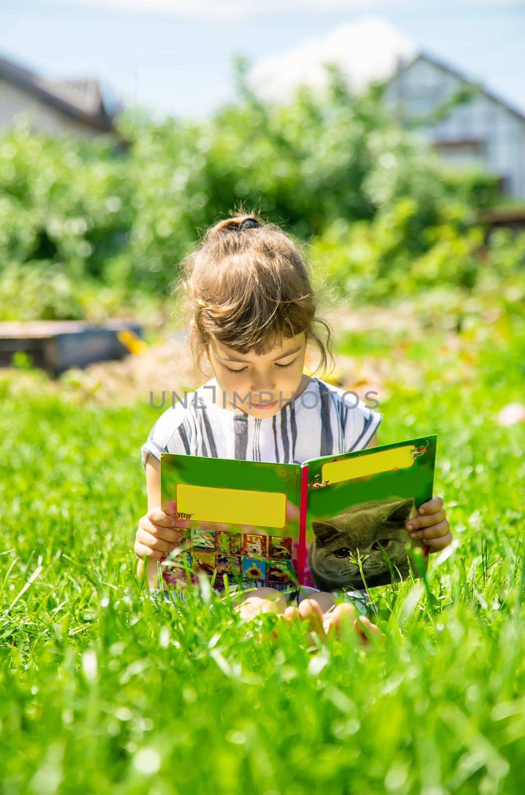 child reading a book in nature. Selective focus. nature.