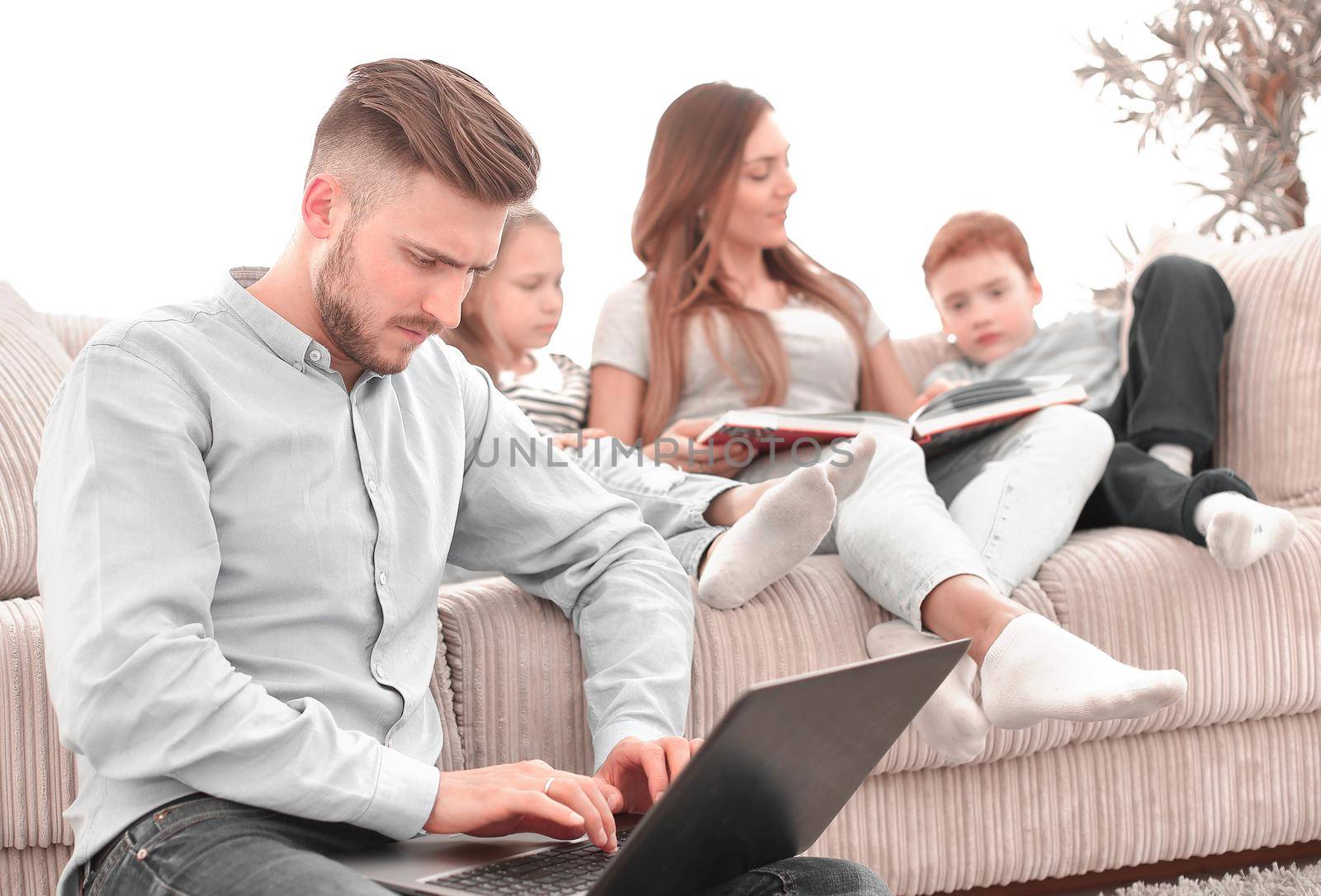 modern man sitting in his living room. by asdf