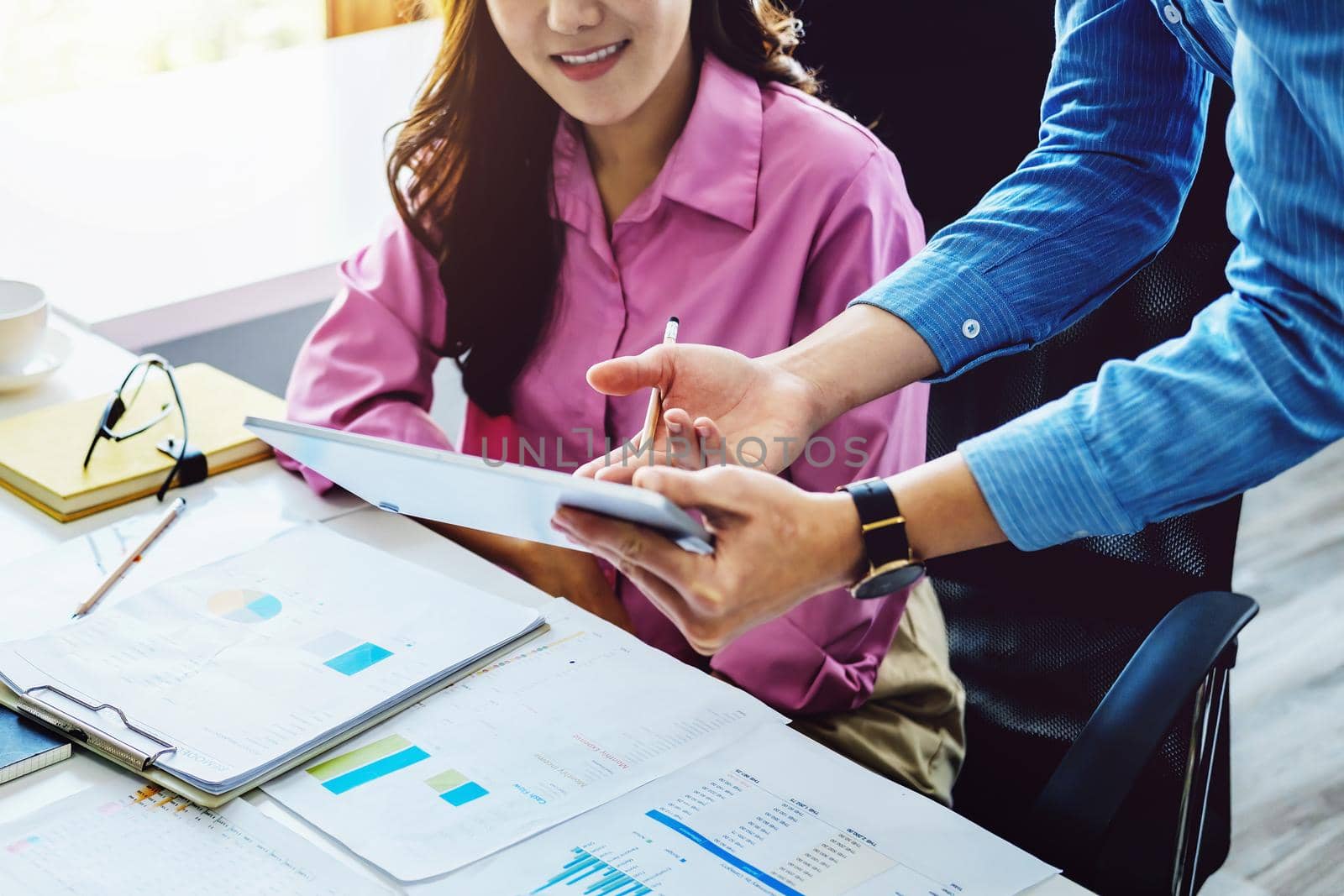 negotiation, analysis, discussion,asian male economist using tablet explaining the investment finance program to the company owner to plan marketing and hedging business risks